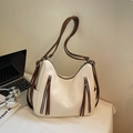 Large beige crossbody bag with brown straps for women, shown in an office setting - Off White