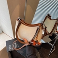 Vintage canvas underarm bag with brown leather trim and horse charm shown in mirror - Off-white