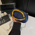 Blue and black snakeskin chain crossbody bag with a large gold ring handle shown held - Blue Snake (4)