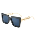 Gafas de sol cuadradas con montura negra y detalle de cadena dorada en patillas - Montura Negra Lentes Grises