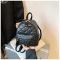 Close-up of black quilted leather mini backpack with luxury gold metal zippers - Black