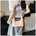 Detail of pink patent leather hobo bag with glossy finish and silver heart charm - Pink