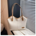 Detail of off-white lychee leather tote bag with dark brown straps and shadow pattern - White