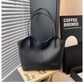 Macro detail of high-quality black litchi grain leather on this large tote bag - Black