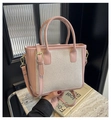 Detail view of woven pink patchwork tote bag with gold hardware and top handle - Pink