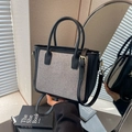Minimalist woven tote bag with black leather trim and golden hardware for women - Black