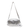 Silver metallic crossbody bag with wide woven strap and white plush charm detail - Silver