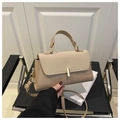 Dettaglio della borsa beige in ecopelle con chiusura dorata e manico superiore - Cachi