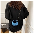 Glossy blue acrylic shell bag with quilted texture and gold chain strap in use - Bright Blue