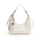 Minimalist white patent leather crescent bag with silver ball charm and sleek shoulder strap - White