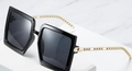 Fashionable oversized square black sunglasses featuring elegant gold chain-link metal temples - Black Frame / Black Lens