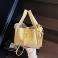 Hellgelbe Beuteltasche aus genarbtem Leder mit goldenem Drehverschluss und Henkel - Gelb