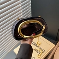 Glossy black-brown clutch bag featuring a bold gold C-shaped handle and chain strap - Black