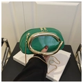 Detail of green patent leather crescent bag with bold gold C-shaped metal handle and chain - Green