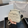 Chic beige quilted round crossbody bag with dual zippers and adjustable shoulder strap - White