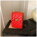 Mini bolso de cuero acolchado rojo con cadena dorada sobre un libro negro - Rojo