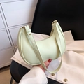 Mint green crescent shoulder bag with adjustable strap and gold zipper detail - Turquoise Green