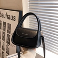 Chic black patent leather handbag with gold 'FASHION & BAGS' text and versatile shoulder strap - Black