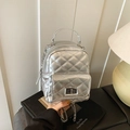 Chic silver quilted mini backpack with metallic chain straps and a twist-lock front pocket - Silver