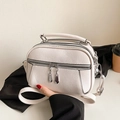 Beige pebbled leather crossbody bag with multiple zippers and silver hardware - White