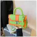 Detail of neon green and orange crossbody bag with silver T-ring buckle and slim strap - Green