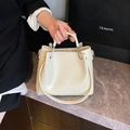 Elegant cream crocodile pattern bucket bag with curved top handle and shoulder strap - White