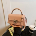 Light pink PU leather crossbody bag with golden bow clasp and metallic handle - Pink