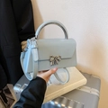 Minimalist light blue handbag with silver bow buckle and semi-circle metal handle - Blue