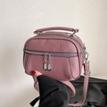 Mauve pebbled leather crossbody bag with triple zipper layers and adjustable strap - Purple