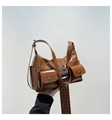 Detail of brown patent leather underarm bag with silver rivets and buckle straps - Brown