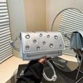 Silver metallic crossbody bag with stylish eyelet studs and knotted woven strap detail - Silver