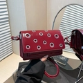Burgundy patent leather flap crossbody bag with silver eyelets and accordion design - Red