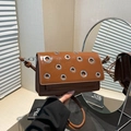 Brown leather baguette shoulder bag with silver grommets and adjustable strap for women - One Size / Brown