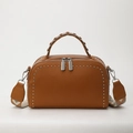 Caramel brown pebbled leather crossbody bag with woven handle and silver stud detailing - Brown