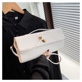 Close-up of white crocodile texture baguette bag with an elegant golden twist buckle - White