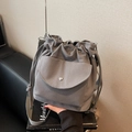 Minimalist grey canvas bucket bag with drawstring closure and comfortable wide shoulder strap - Gray