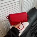 Red pebble grain leather crossbody bag with simple flap design and long shoulder strap - Red