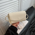 Chic beige crossbody bag with premium lychee grain texture and minimalist flap design - White