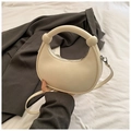 Chic cream-colored half-moon crossbody bag with pebble texture and knot handle detail - White