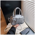Detail of silver metallic handbag with bow accent and leather strap decoration - Silver