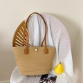 Beige woven straw tote bag with brown leather handles and decorative pearl button - Khaki