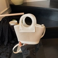 Beige woven shell bag with cream leather trim and unique circular cutout handle - White