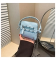 Détail du mini sac bleu clair en cuir grainé avec rivets et bandoulière en chaîne - Bleu