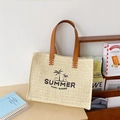 Beigefarbene gewebte Strohtasche mit schwarzem Summer Stickerei und Ledergriffen - Weiß