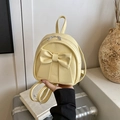 Mini backpack in pale yellow faux leather with large decorative bow on the front - Yellow