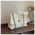 Elegant white faux leather handbag with a round silver buckle and lace bow detail - White