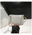 Detailed view of silver metallic leather shoulder bag with woven eyelet texture - Silver