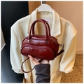 Chic burgundy bowling handbag in glossy faux leather with silver hardware and shoulder strap - Red