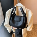 Chic black lychee texture crossbody bag with unique dual handles and adjustable strap - Black