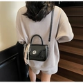 Glossy black mini handbag with silver twist lock and colorful tassel on stairs - Black With Pendant